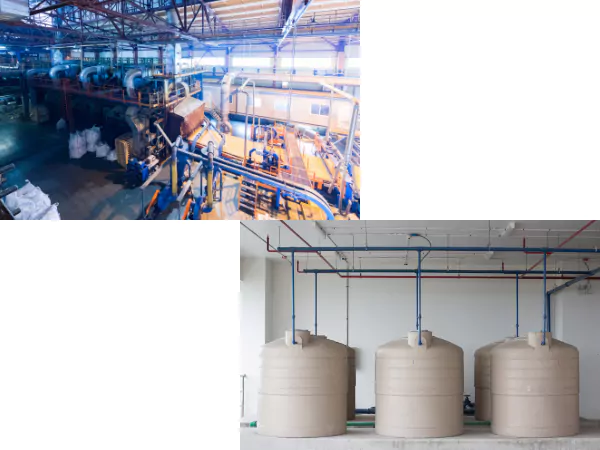 Hall industriel avec machines et tuyauteries, et trois cuves cylindriques beiges raccordées à des conduites dans un local technique